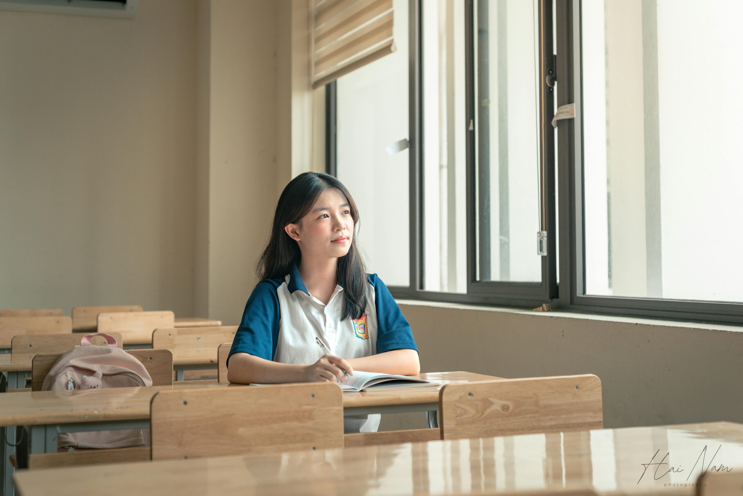 Young student looking out the window thinking about his future and success