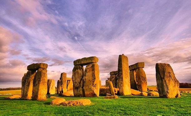 Ancient Stonehenge monument under a clear blue sky in England